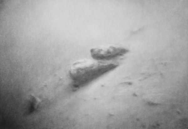 2 stones on sandy or muddy and foggy surrounding on a hill